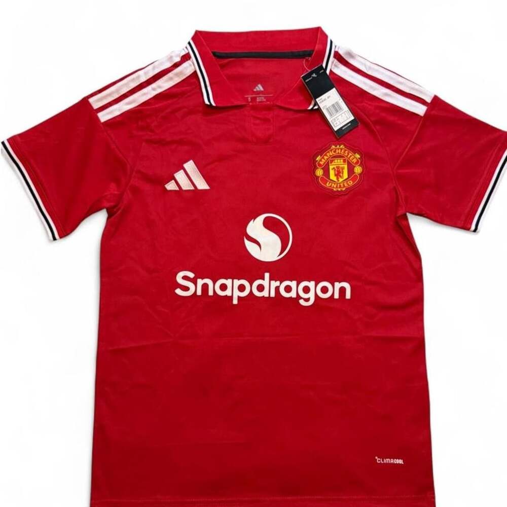 Adidas Manchester United 20256/27 home shirt in red with white stripes on should